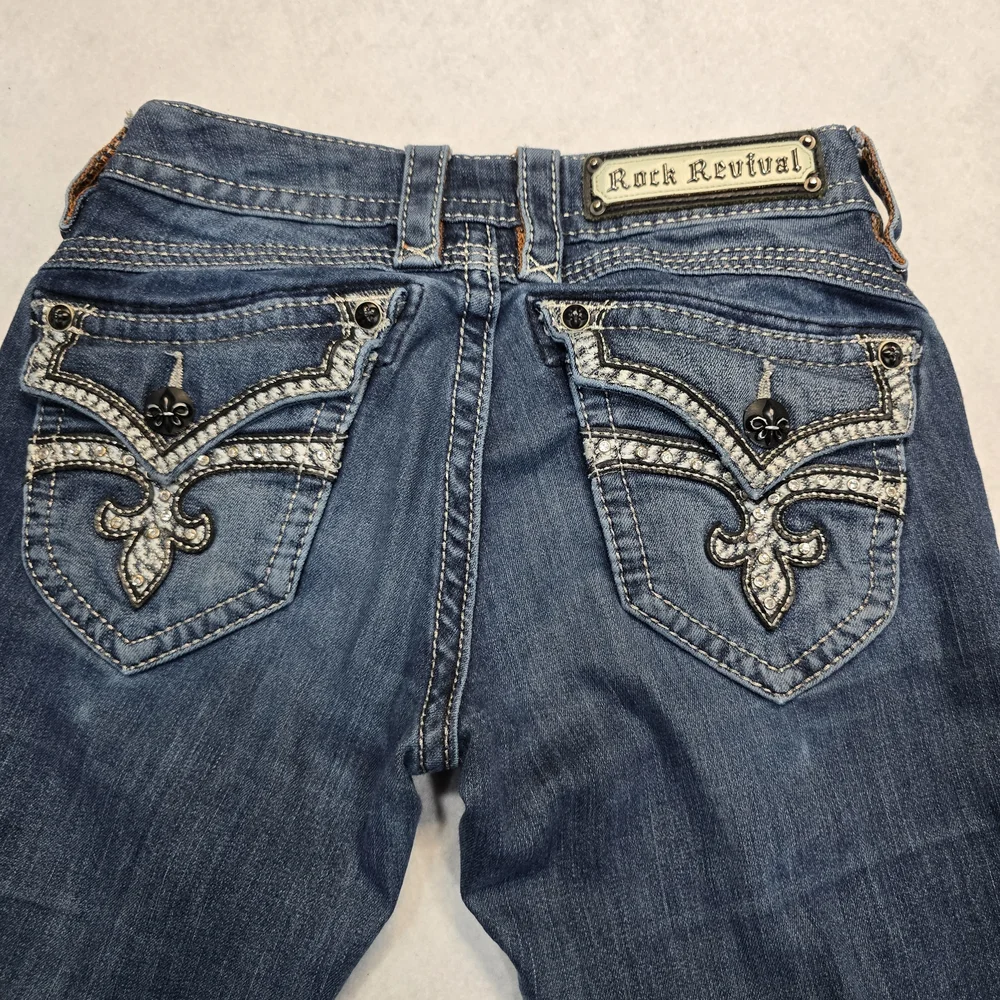 Rock Revival Stephanie Capri Jeans Blue Distressed Rhinestone Fleur De‎ Lis 25